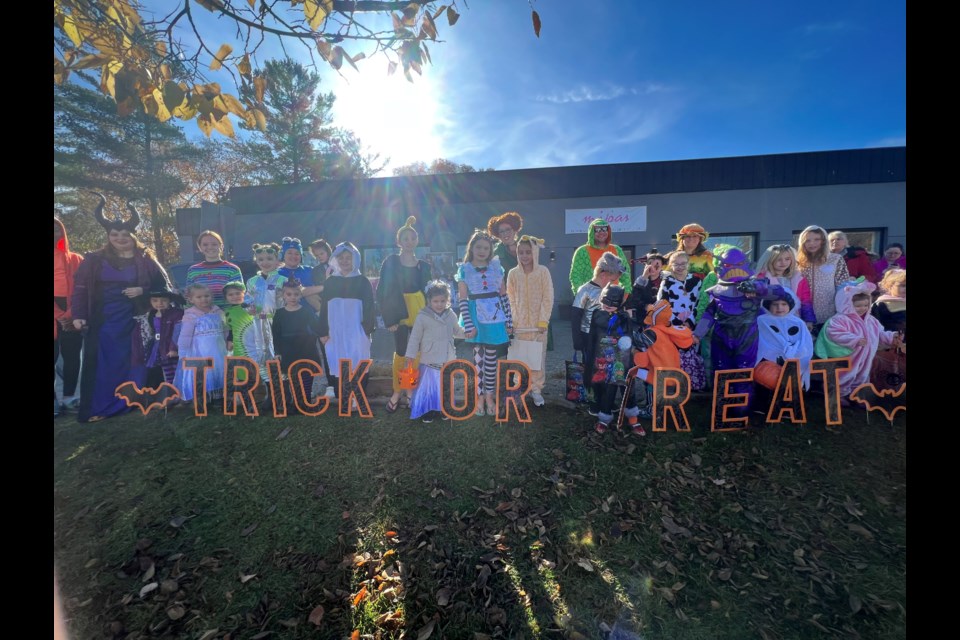 In a dress rehearsal for Halloween on a sunny Saturday, these two photos feature some of the 375-400 trick-or-treaters that visited the co-organizers and about 10 other businesses outside of Miss Jennie’s Performing Arts Studio and Johnny Burger.