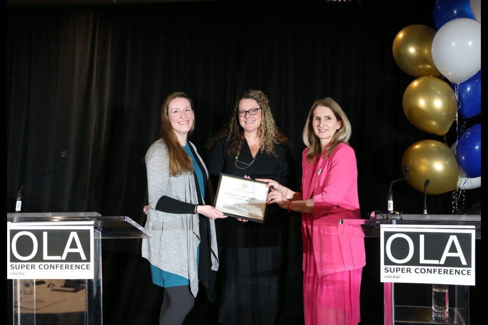 Innisfil ideaLAB & Library staff are shown with the Angus Mowat Award of Excellence. From left: Megan Legg, manager of programming and outreach, Erin Scuccimarri, library CEO, and Laura Smith, parliamentary assistant to Neil Lumsden, the minister of tourism, culture and sport.