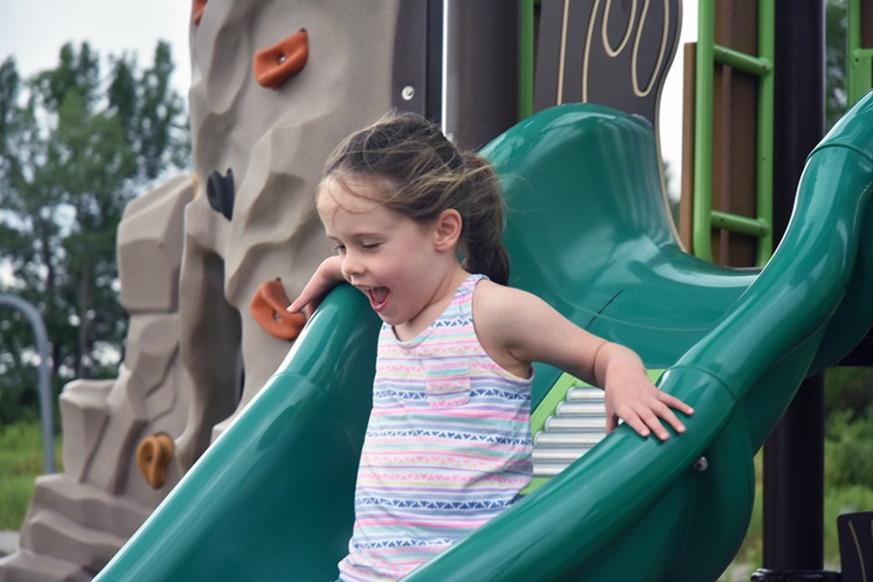 Alyssa, 5, enjoys her first slide in months, at Innisfil's Centennial Park. Miriam King/Innisfil Today