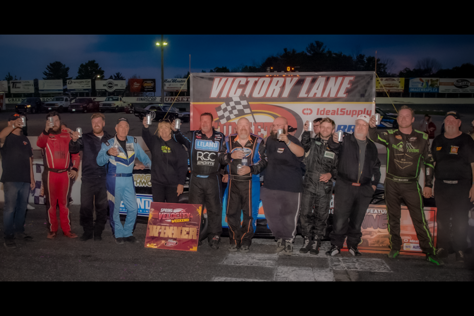 Mark Dilley celebrates in victory lane along with the other Hot Rod Drivers as they honour Bill Zardo Sr with a toast.