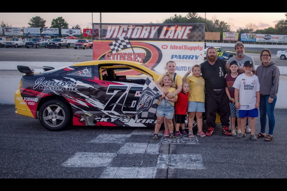 Chris Allard finds victory lane once again and celebrates with his family after a hard-fought win during Fight Under the Lights at Sunset Speedway.