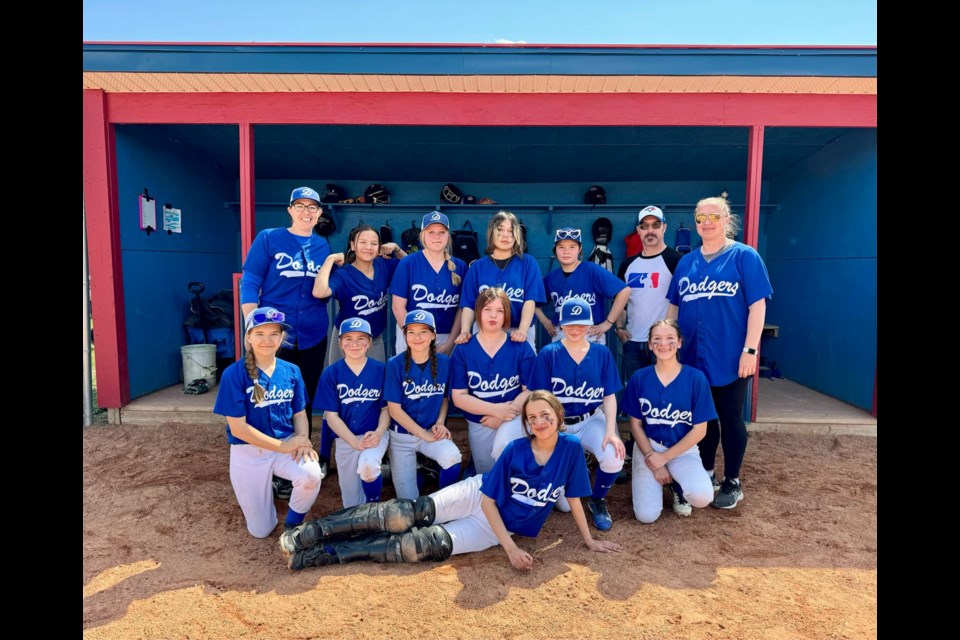 Photo: the lineup for the 2024 Lac La Biche Dodgers U13 girls’ softball team.
Back row, left-right: Joanne Bobocel (coach), Aleira North, Aleigh Lett, Paris Poitras, Jazsika North, Alex Lett (coach), Heather Lett (coach).
Middle row, left to right:
Kaylin Beniuk, Annie Routhier, Lillian Bobocel, Cristiana Boucher, Layla Sanderson-MacDonald, Isabella Boucher.
Front: Piper Roy.
Missing from photo: Randay Flumian (coach), Asian Flumian, Gracie Mihalcheon, Abigail Laboucane, and Maria Langevin. Photo supplied. 
