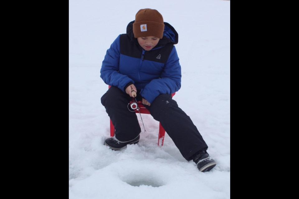 Aidan Pasok concentrates as he waits for the fish to start biting. Pasok joined other folks who gathered on the frozen surface of Lac La Biche Lake on Sunday, Dec. 29  for an afternoon of ice fishing. Chris McGarry photo.