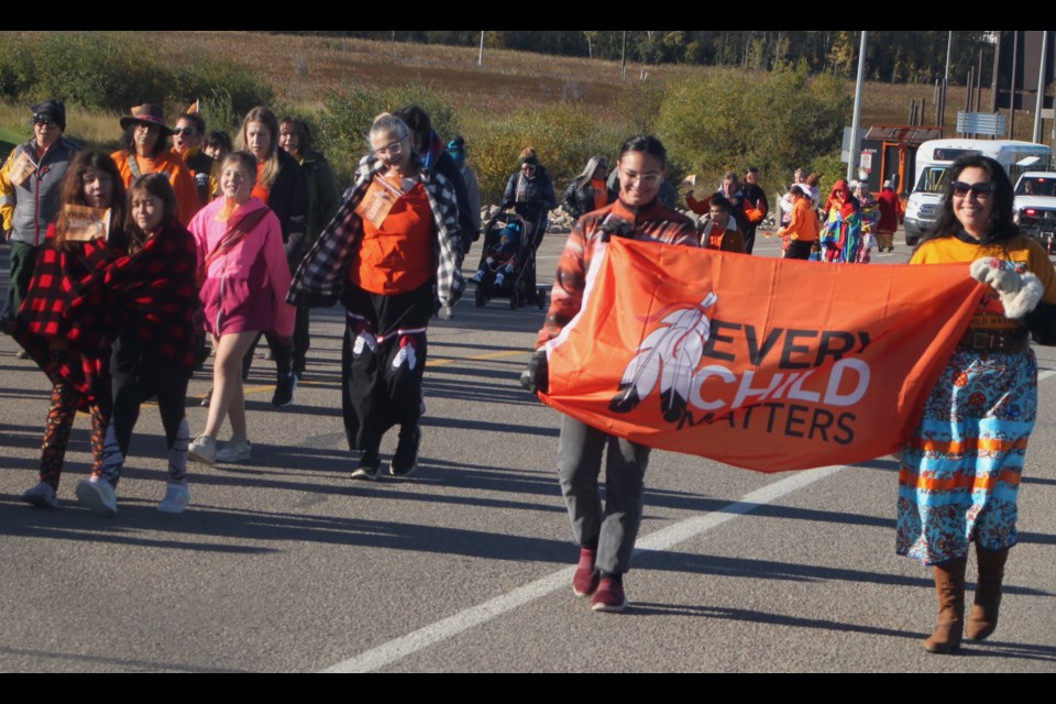 Lexis Roy and Danielle Patenaude carry a large banner bearing the ‘Every Child Matters’ slogan during the walk that took place on Monday morning as part of National Day for Truth and Reconciliation events in Lac La Biche. Chris McGarry photo. 