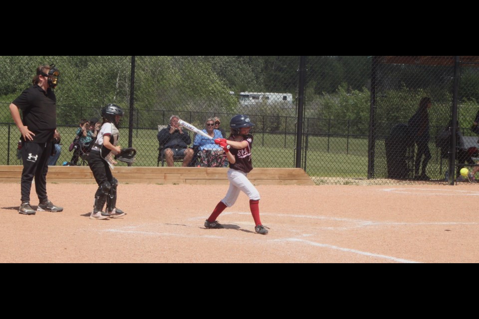 St. Paul Storm batter Aliyah Michaud gets ready to swing as the ball flies towards her. Chris McGarry photo. 