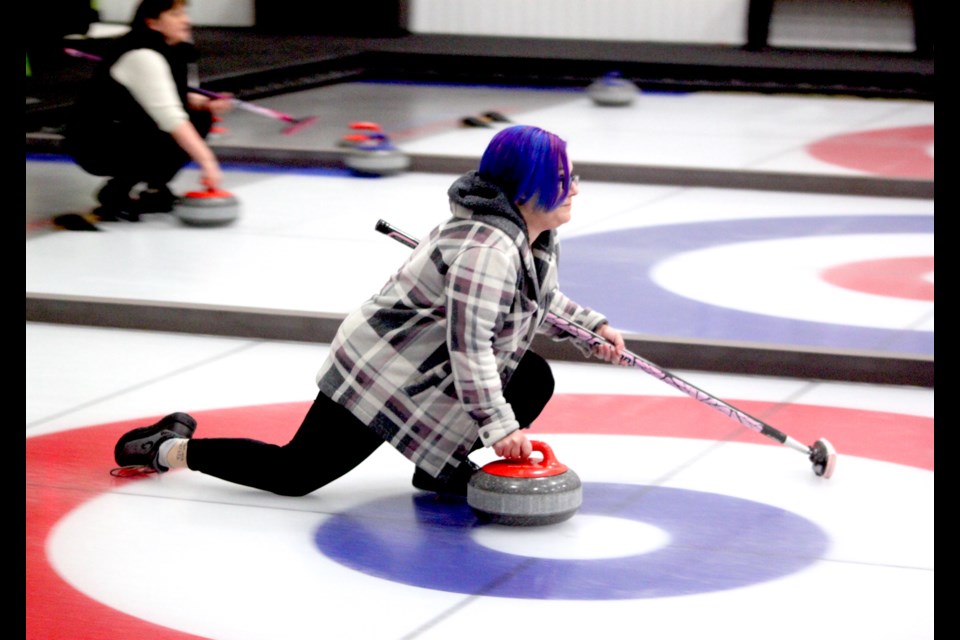 Amanda Paré focuses as she slides down the ice with the rock during a game at the fourth annual Ladies Curling Bonspiel, which took place from March 14-15 at the Lac La Biche Curling Club. This year’s tournament featured 12 teams from Lac La Biche, Plamondon, Boyle, and St. Paul. Chris McGarry photo. 