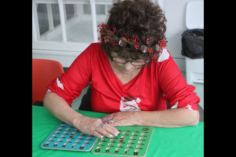 Annette Gingras was dressed in festive colours for the holiday season as she participated in the Old-Fashioned Christmas Bingo event which took place at the Lac La Biche Mission on Sunday, Dec. 15. Chris McGarry photo. 