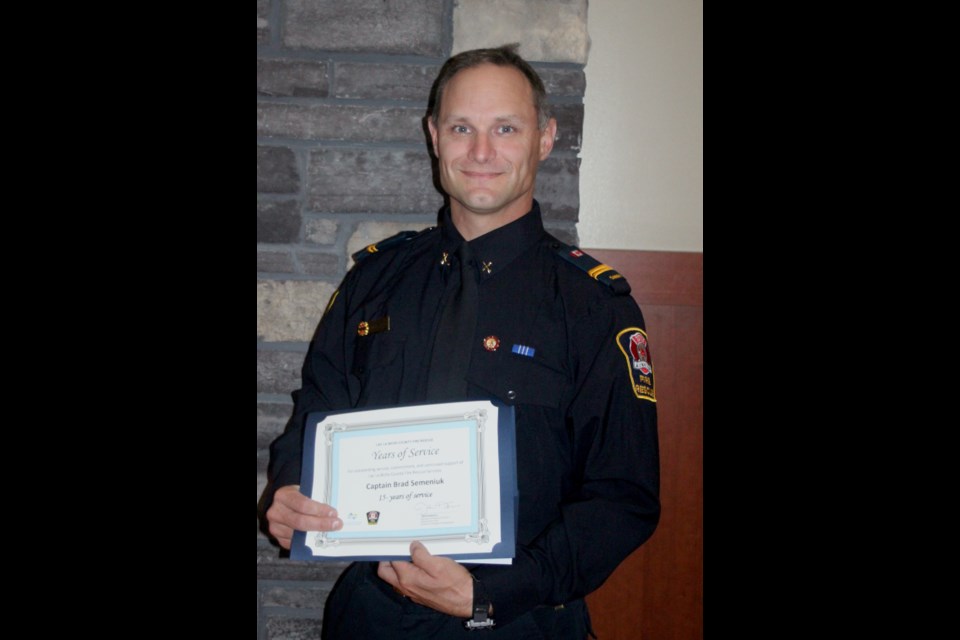 Brad Semeniuk, a 15-year veteran of Lac La Biche County Fire Rescue Service, was awarded with a pin marking his years of service. Chris McGarry photo. 