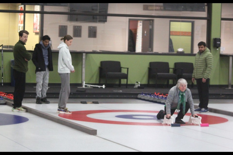 Brenda Robitaille, manager of the Lac La Biche and District Curling Club, demonstrates a sliding technique to some of the people who turned out for the Jan. 24 Friday Fun Night. Chris McGarry photo. 