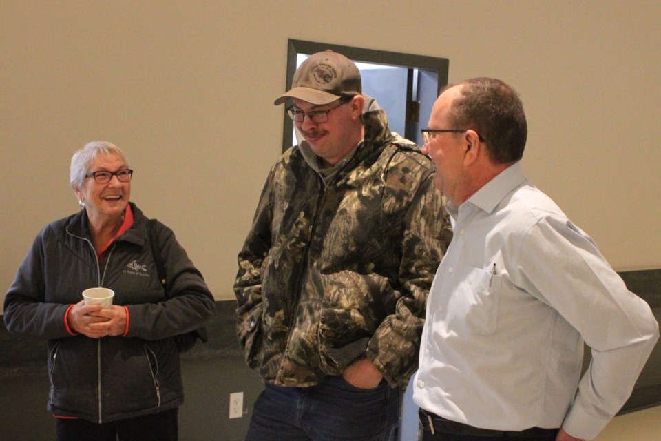 Buzz Brown, chief operating officer for Red Wolf Corporation, chats with Brannon Schalin and Simone Cadieux during the open house that took place in Hylo on Saturday, Nov. 30. 