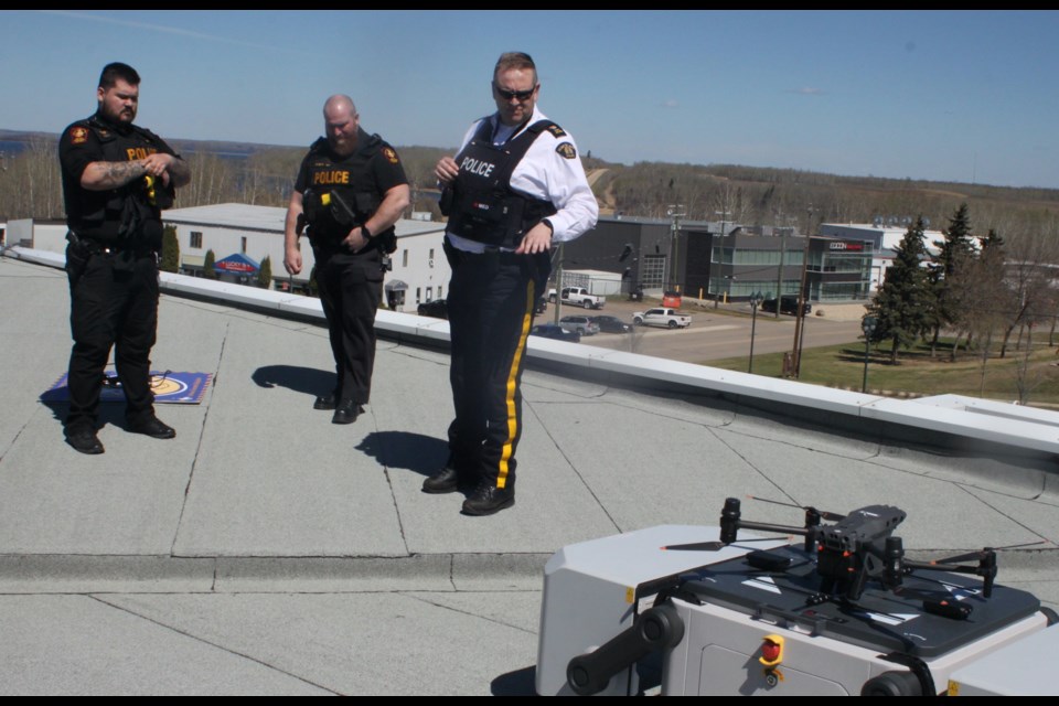 Inspector Corey Blize of the Alberta RCMP shows members from the military police (MP) group out of 4 Wing at Canadian Forces Base Cold Lake the DJI M30T Remotely Pilot Aircraft System (RPAS) drone that was used during Thursday’s training scenario involving RCMP tracking and apprehending an armed robbery suspect with the assistance of RPAS. These MPs were on hand to observe the exercise. Chris McGarry photo.  