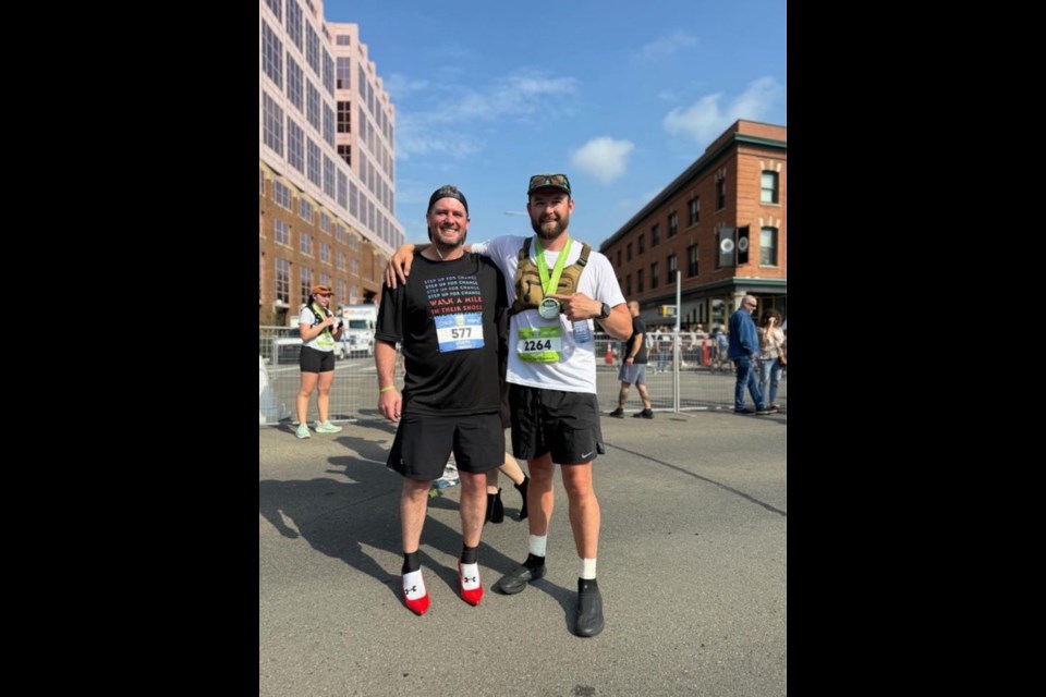 Curtis Hargrove (left) stands alongside a fellow contestant at the Edmonton Marathon on Aug. 16, where he sported high heels to raise awareness and funds for the Stepping Stones 
Crisis Society.
Photo supplied