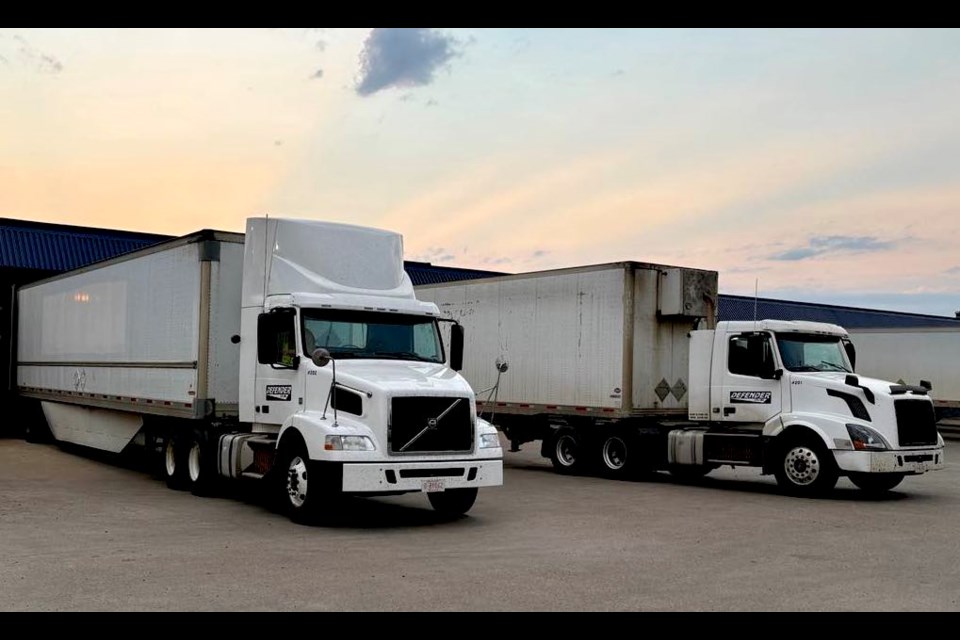 The two tandem axle tractor trailers that are part of Defender's six-vehicle fleet at the company depot in Bonnyville. Photo supplied. 