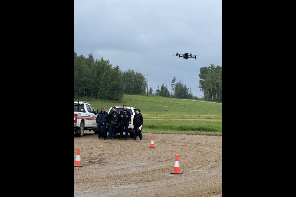 John Kokotilo, Lac La Biche County's general manager of protective services and regional fire chief, far left, stands with members of the County's enforcement services branch during a drone training exercise held in 2023. File photo. 