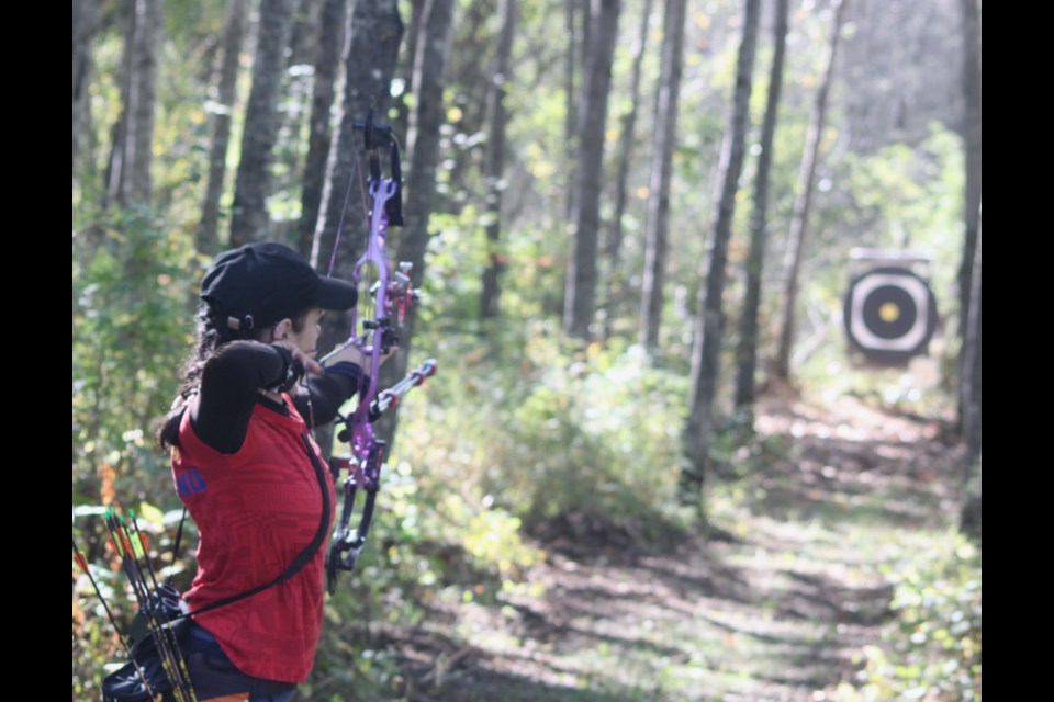 Romanian archer Elena Topliceanu takes aim at a target on one of the courses in the forest near the Lakeland Archers range. Chris McGarry photo. 