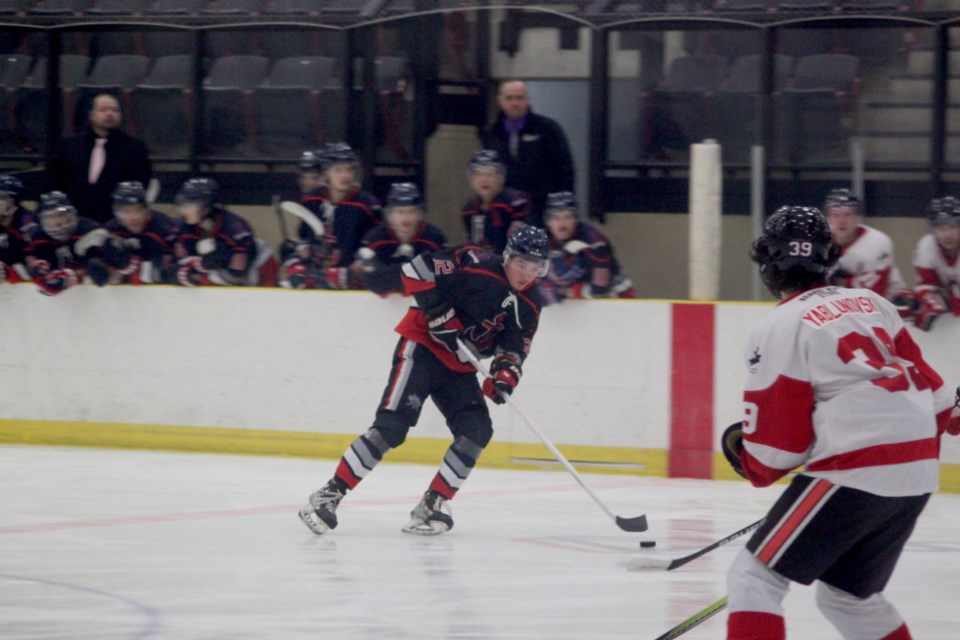 Eli Quinney of the Lac La Biche Lakers is watched by Crowsnest Crush defenseman Ariel Yablunovsky as he moves towards the Crowsnest zone. Chris McGarry photo. 