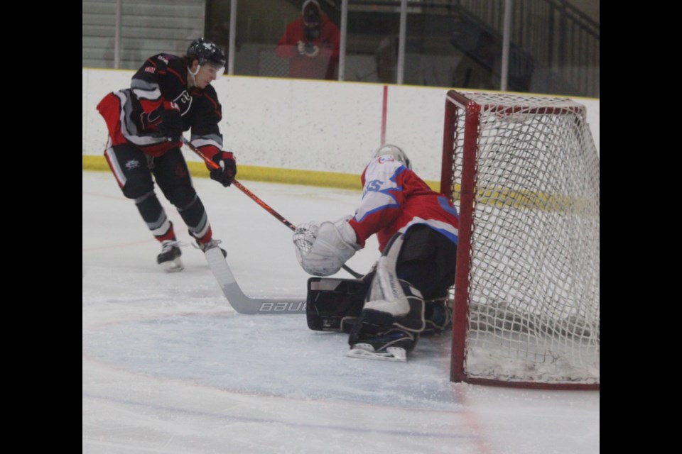 Lac La Biche Lakers forward Ethan Christian launches an attack on the net of Northern Alberta Lightning goaltender Oliver Levy during the game between the two National Junior Hockey League (NJHL) squads at Lac La Biche’s Bold Centre on Feb. 14. The Lakers, who hold second place in their five-team NJHL North Division, won the contest 12-0. Chris McGarry photo. 