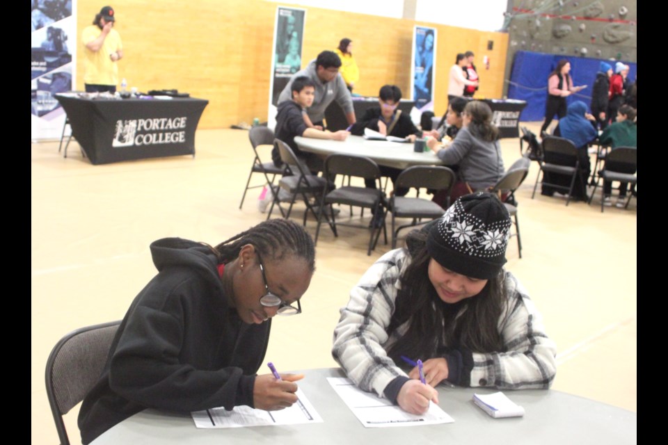 Cybilmae Bada and Faith Okonta fill out some applications at the open house event. Chris McGarry photo. 