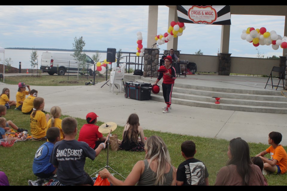 Calgary-based showman Bob Palmer, a.k.a. Flyin’ Bob, entertains members of the audience who’d gathered for the Carnival in the Park event. Chris McGarry photo. 