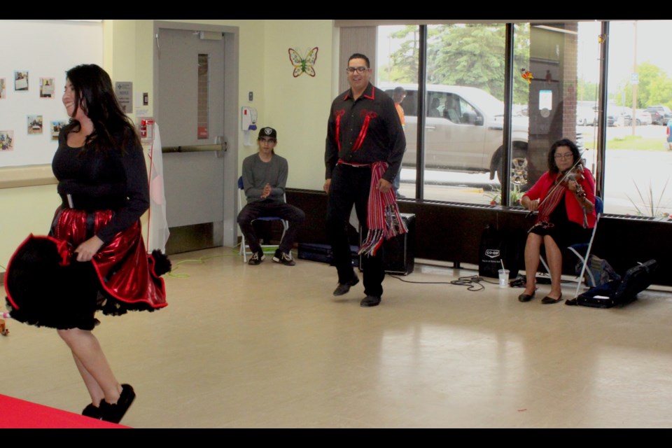 Members of the Kikino Northern Lights Metis Dance Troupe performed for the residents of the extended care unit of the William J. Cadzow Healthcare Centre in Lac La Biche on Wednesday, June 26. In photo are Ross Hope (sitting), Danielle Patenaude (dancer), Karen Dion (fiddle), and Trevor White (dancer). Chris McGarry photo.
