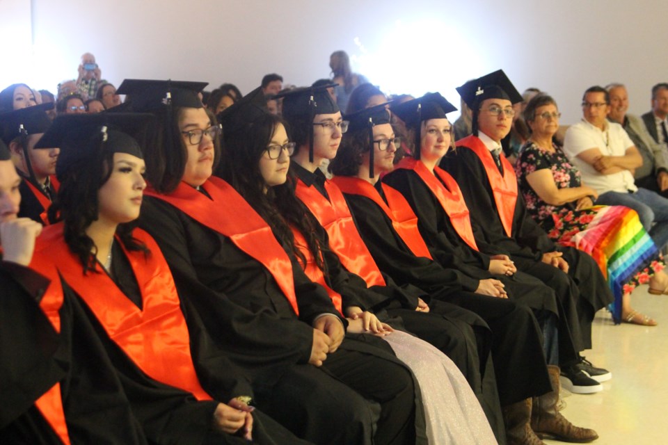 The front row of the Cold Lake Outreach School graduates wait to receive their diplomas. 