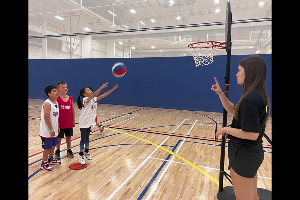 Hannah Williams, a recreation programmer for Lac La Biche County, instructs some participants in the Jr. NBA program. Photo supplied. 