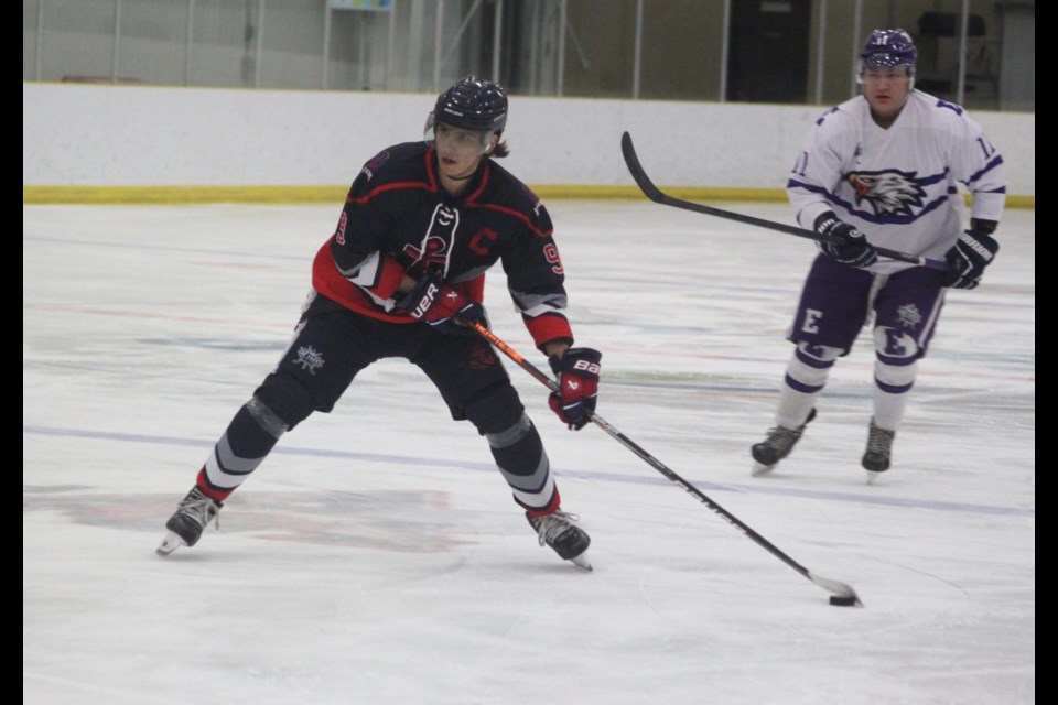 Lac La Biche Lakers' Hayden Desjarlais looks down the ice as he prepares to shoot the puck while Zane Campbell-Gunn of the Edson Eagles approaches him from behind. Chris McGarry photo. 