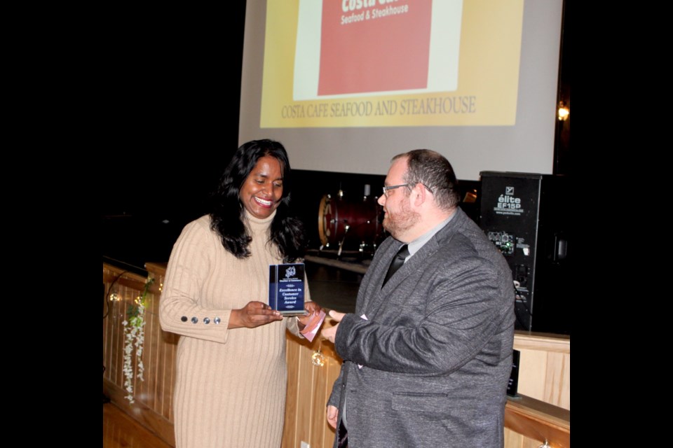 Hazel Costa of Costa Cafe accepts the Excellence in Customer Service Award from Dylan Craig of the Lac La Biche and District Chamber of Commerce. 