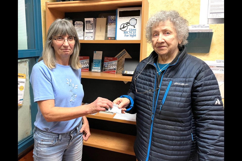 Lac La Biche Registries owner Carol St. Jean accepts the license of Ellen Gargus, believed to be the first woman in Lac La Biche to get a driver’s license. Ellen turned 88 on December 23 and handed in her license after 69 years of motoring.