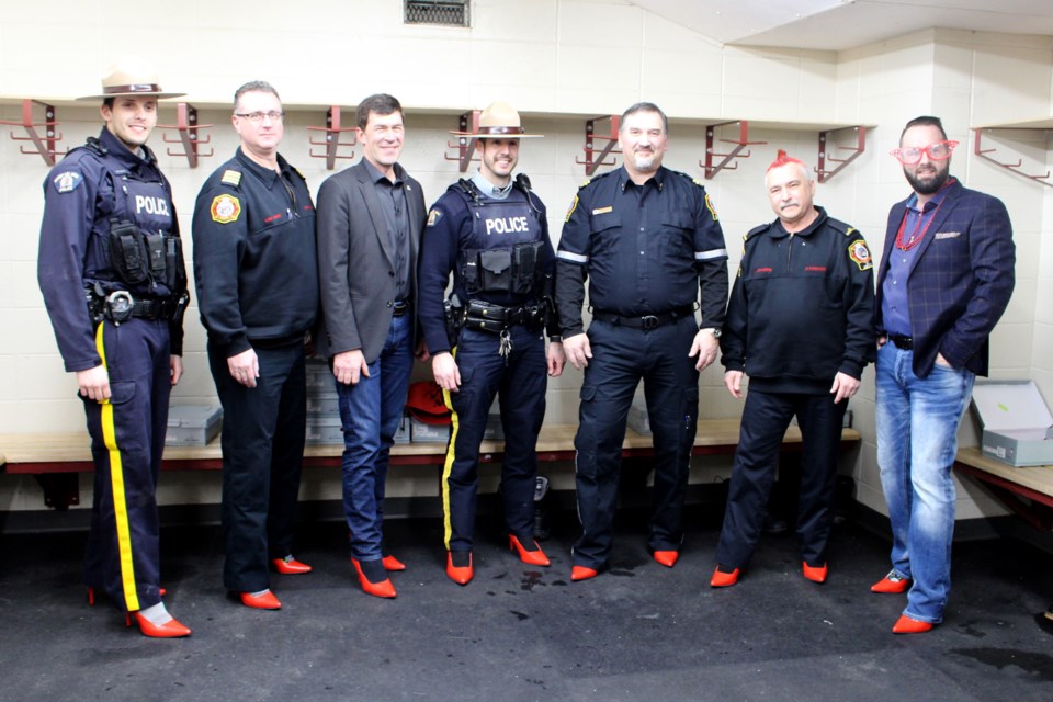 Men from the Town and MD of Bonyville council, Bonnyville RCMP, and Bonnyville Regional Fire Authority participated in the Dr. Margaret Savage Crisis Centre’s Walk a Mile in Her Shoes fundraiser on Friday, Feb. 1.   Photo by Robynne Henry. 