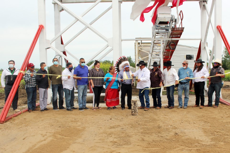 Representatives from Frog Lake First Nations, Waskonaman Ashik Construction, and Noble Concrete cut a ribbon in front of the plant during their July 21 ceremony. Photo by Robynne Henry. 