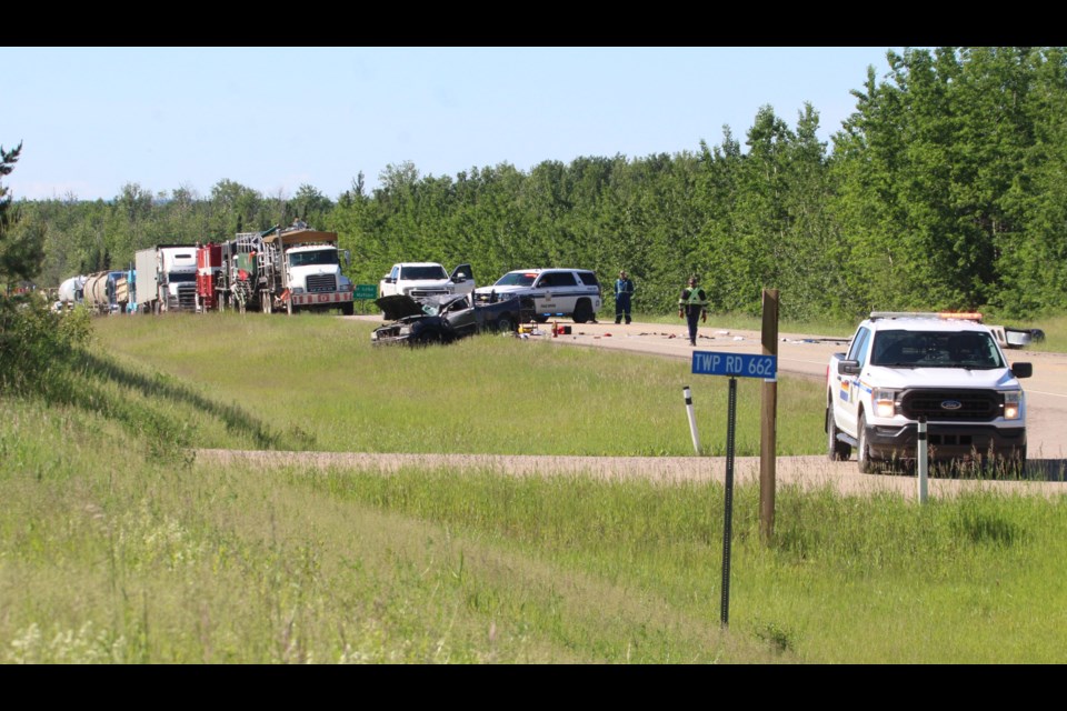 Crash investigators look over the scene of a Friday morning crash at the intersection of Highway 36 and  Township Road 662 about five kilometres south of Lac La Biche. The crash closed a section of the highway. Injury reports were not immediatedly released by the RCMP