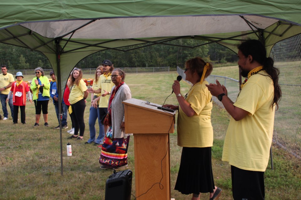 Stephen Wright, recovery coach and event organizer, gives a speech at the Walk for Wellbriety, alongside Executive Director Laura Saffroniuk.