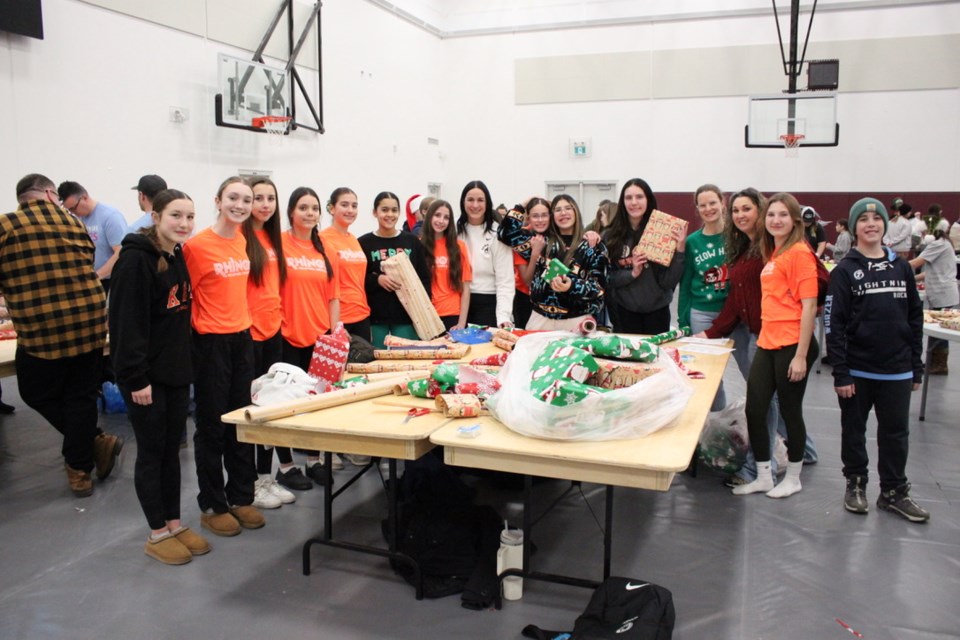 The Rhinos 14U girls Volleyball team volunteered to wrap gifts for the Santa's Elves program at BCHS.