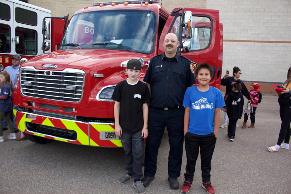 From the left, Kestin Simons, Rory Mang, and Dre Singer hang out outside the Fire hall during the station 5 open house.