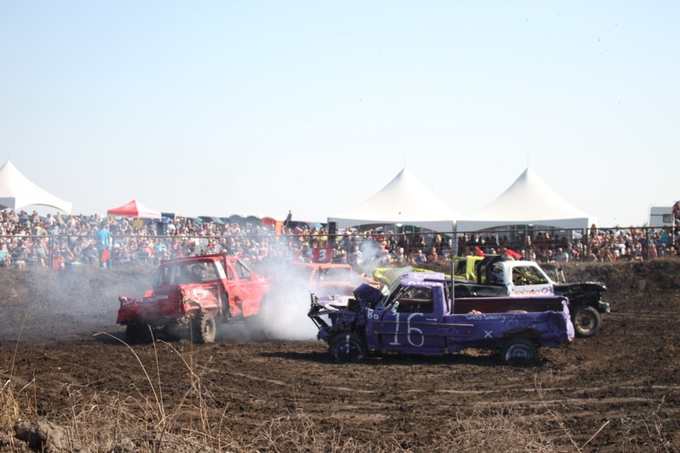 Smoke and dust filled the air as derby vehicles tore up the arena.