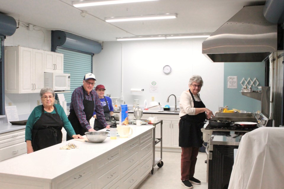 Volunteers worked hard in the kitchen to cook a buffet breakfast at Bonnyville's Senior Drop-in Centre's Pancake Breakfast. From the left: Mary Ann Dukin, Louis Herbert, Aggi Wasylyk,  and Donna Worden.