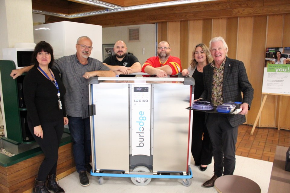 From the left: Dawn Weber, Brian McEvoy, Neil Langridge, Byron Johnson, Kayla Blanchette, and David Sharun, pose with the hospital's new food service cart.