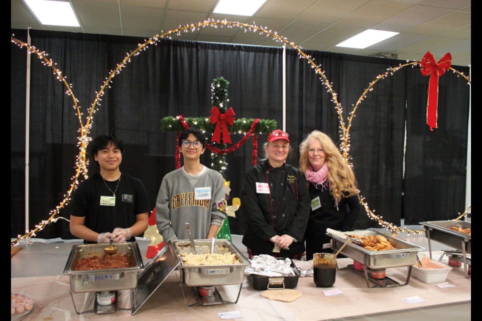 Volunteers served up international and canadian fair at the Feast of Nations hosted by the Bonnyville Community Church. From the left: Justin Ocampo, Jacob Daugdaug, Lorranda Ledrew, and Marge Woods.