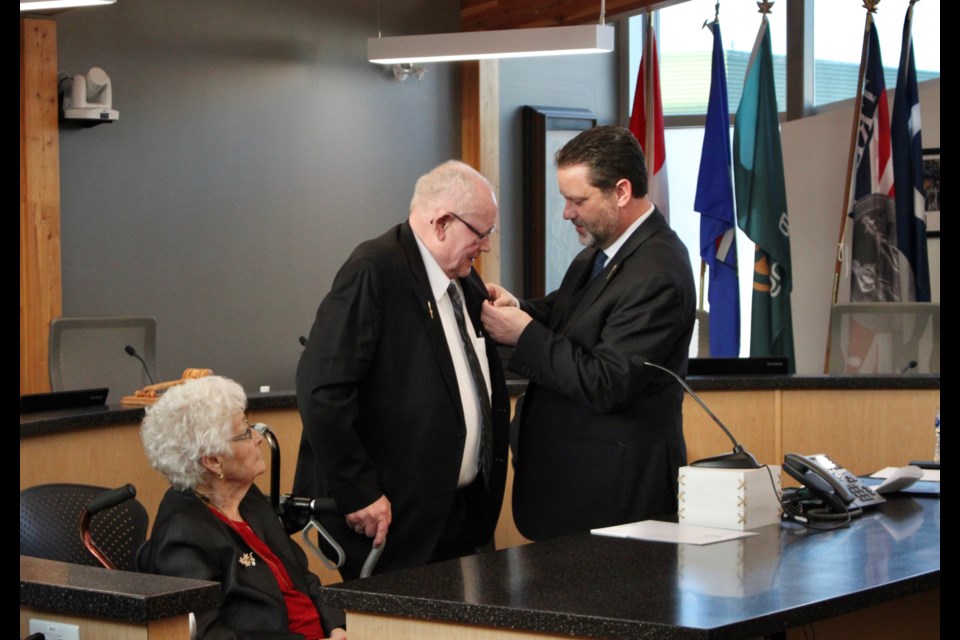 Ernie Isley received his King Charles III Coronation Medal earlier this month. Pictured from the left are Sheila Isley (sitting), Ernie Isley, and current Bonnyville-Cold Lake-St. Paul MLA Scott Cyr. 