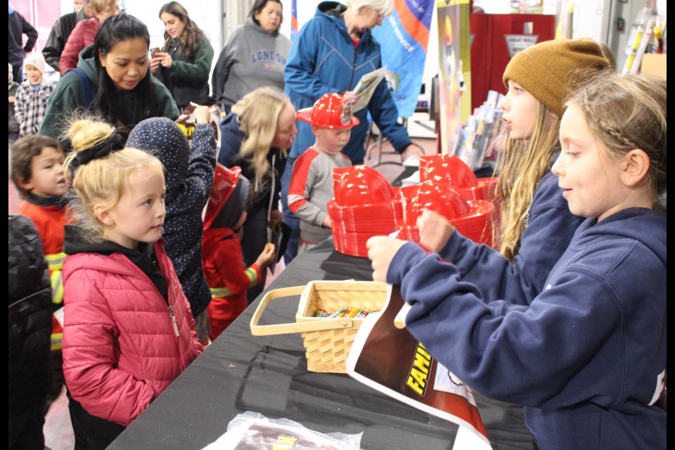 Some BRFA volunteer that are too young to fight fires, Pearl and Ruby Wasylciw, helped by handing out swag bags at the Bonnyville fire hall's annual open house.