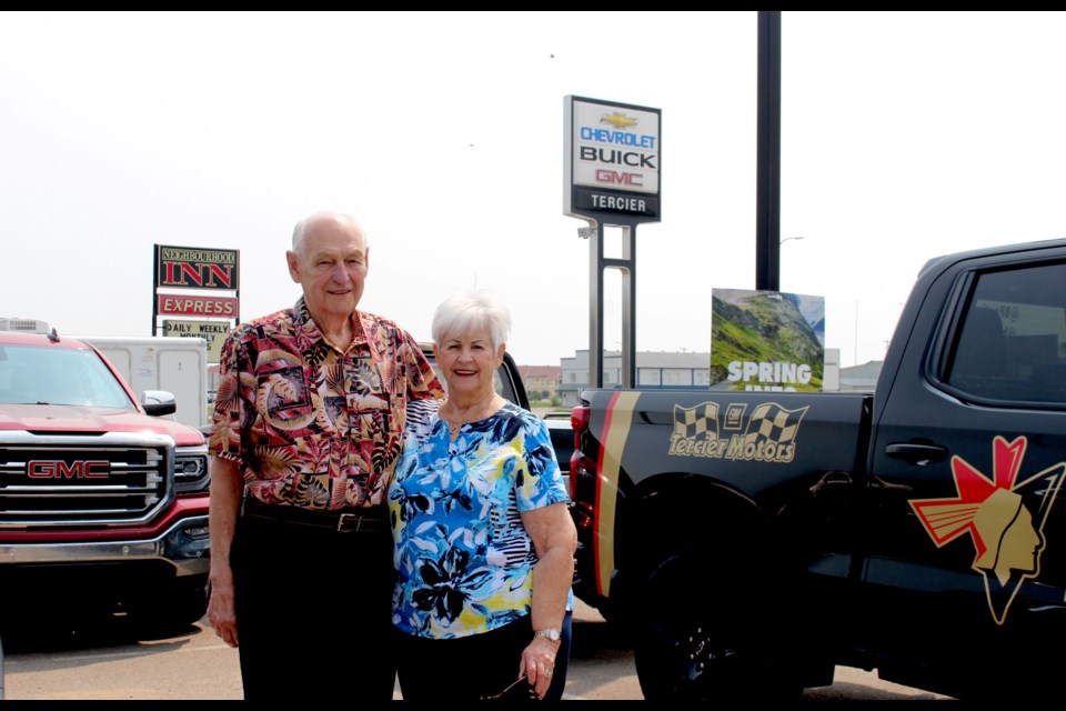 Ed and Lorraine Tercier stand beneath the Tercier Motors sign during a 65-year celebration held on June 10. Tercier Motors Ltd. was officially opened on April 5, 1958.