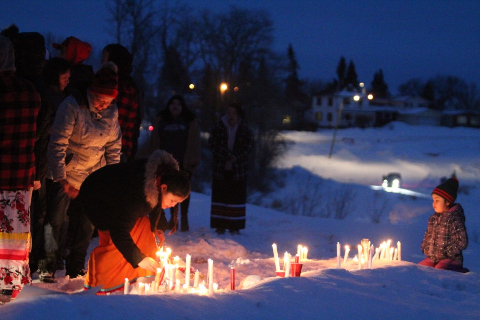 Hundreds of candles were left by those attending the Sunday night vigil along the Lac La Biche shoreline, honouring Tytiana Janvier.     Image Rob McKinley