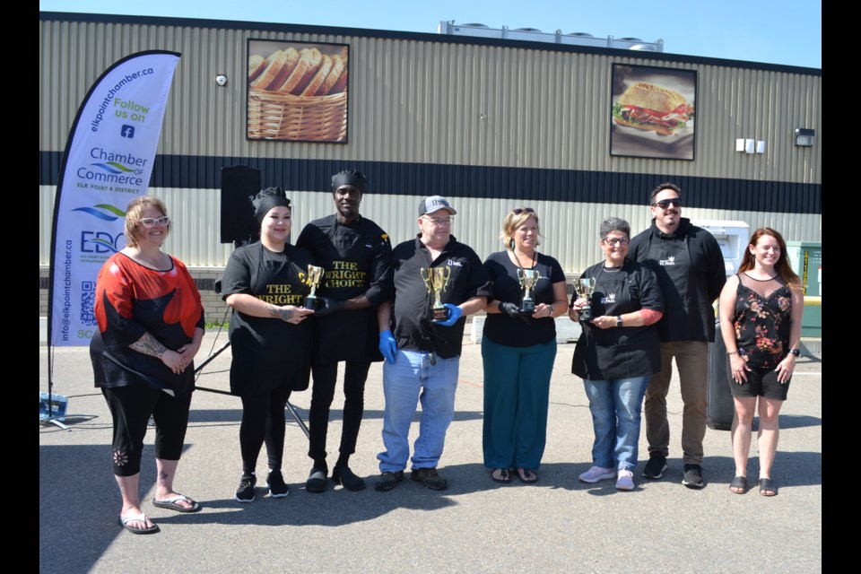 Elk Point and District Chamber of Commerce president Terri Hampson (left) and Town of Elk Point recreation coordinator Caitlyn Bush (right) presented trophies from the Chamber and Town to Chili Cook-off winners Brittany and Junior Wright of ‘the Wright Choice’, Dave Robinson of Bumper to Bumper, Kathryn Vasseur of Apidae Compassionate Care, Town of St. Paul Mayor Maureen Miller and CAO Steven Jeffery.