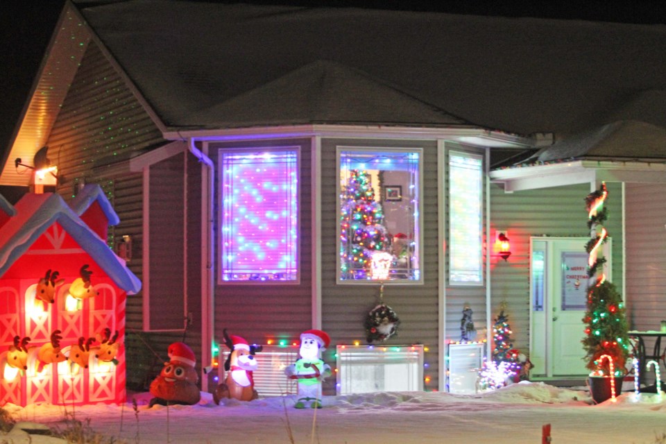 This decorated house along 99 Avenue near the water tower even has a stable for Santa's renideer.   Image Rob McKinley