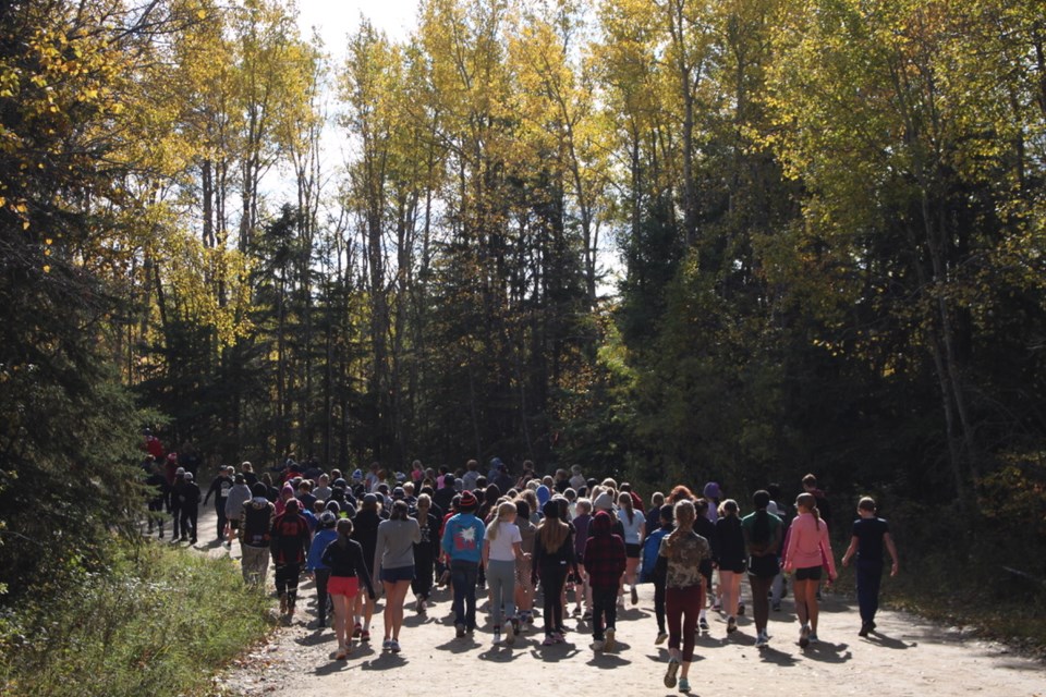 A group of students head down the forest lane at the beautiful Cold Lake Provincial Park, to start their cross country run race.