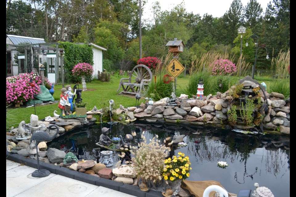 Flowers, flowers everywhere are a sure sign of the amount of very pleasurable work Lorraine Stybel puts into this beautiful yard, with the pond in the foreground just one of its many attractions.