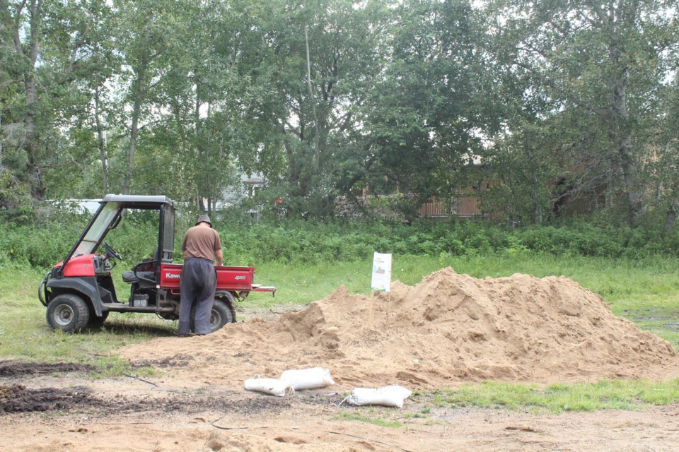 A Mission area resident at the sand and sandbag drop-off. Municipal officials have set up several of the locations at lakeside communities to help residents battle rising lake levels.