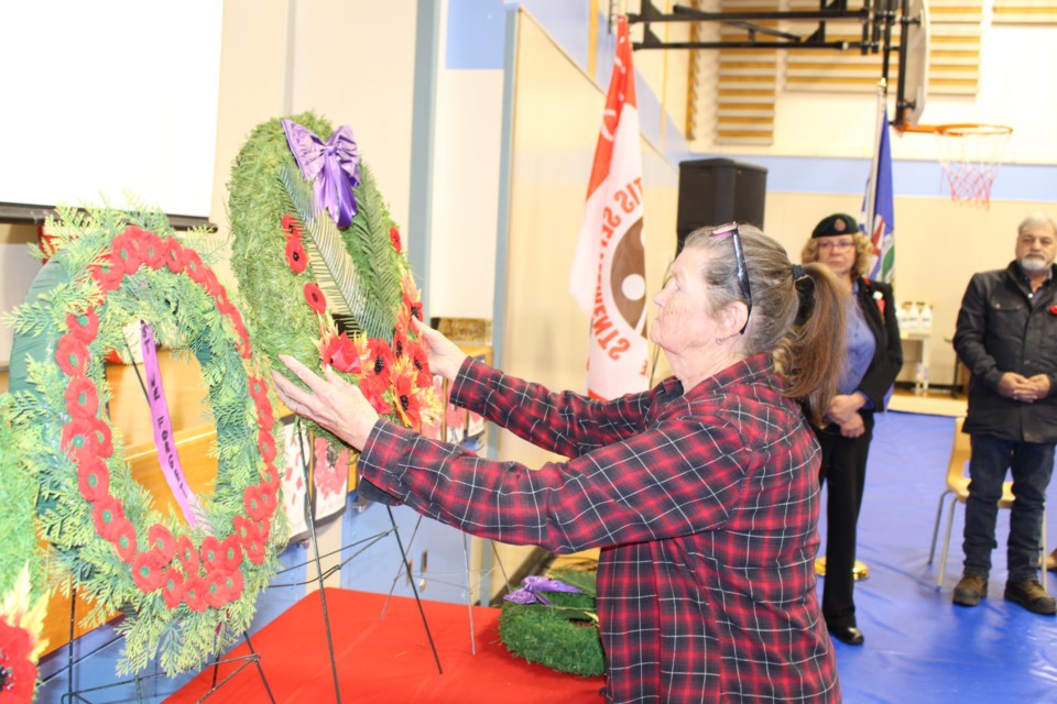 Kikino's Lynda Knelson displays the wreath for the veterans of the Korean War.    -- Photo Brad White