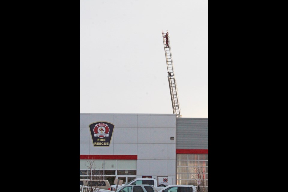 A Lac La Biche County firefighter at the top of the 75 foot aerial ladder during a recent training session at the Protective Services Building.